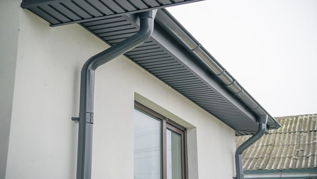 Seamless aluminum gutter system installed along a residential roofline