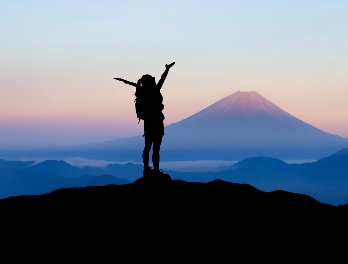 healthy woman hiker on top of mountain