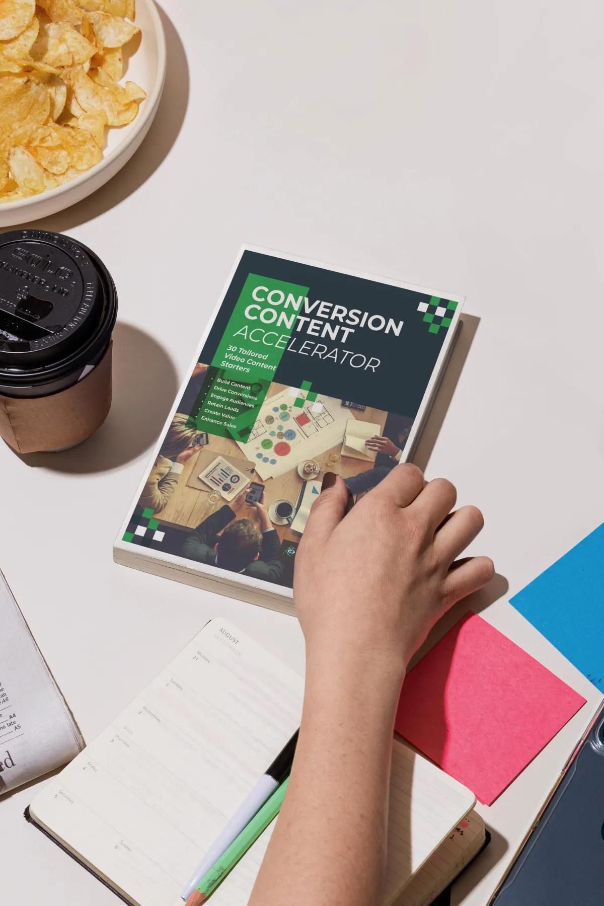 Image of a hand holding a copy of the Conversion Content Accelerator document