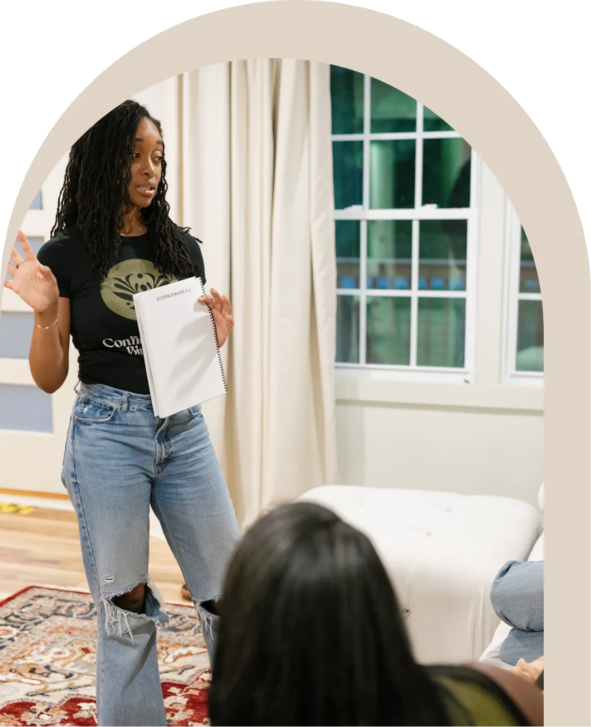 Woman leading a faith-based birth preparation class speaking to a small group