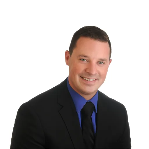 Professional portrait of a realtor in a suit, representing Ottawa Properties, emphasizing personalized real estate services and consultation availability.