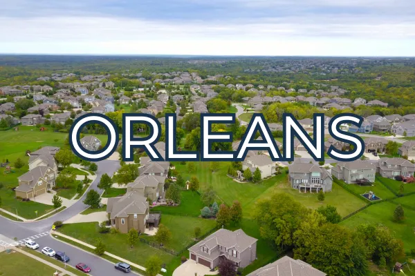 Aerial view of suburban homes in Orleans, Ottawa, with "ORLEANS" prominently displayed, representing family-friendly neighborhoods in the Ottawa real estate market.