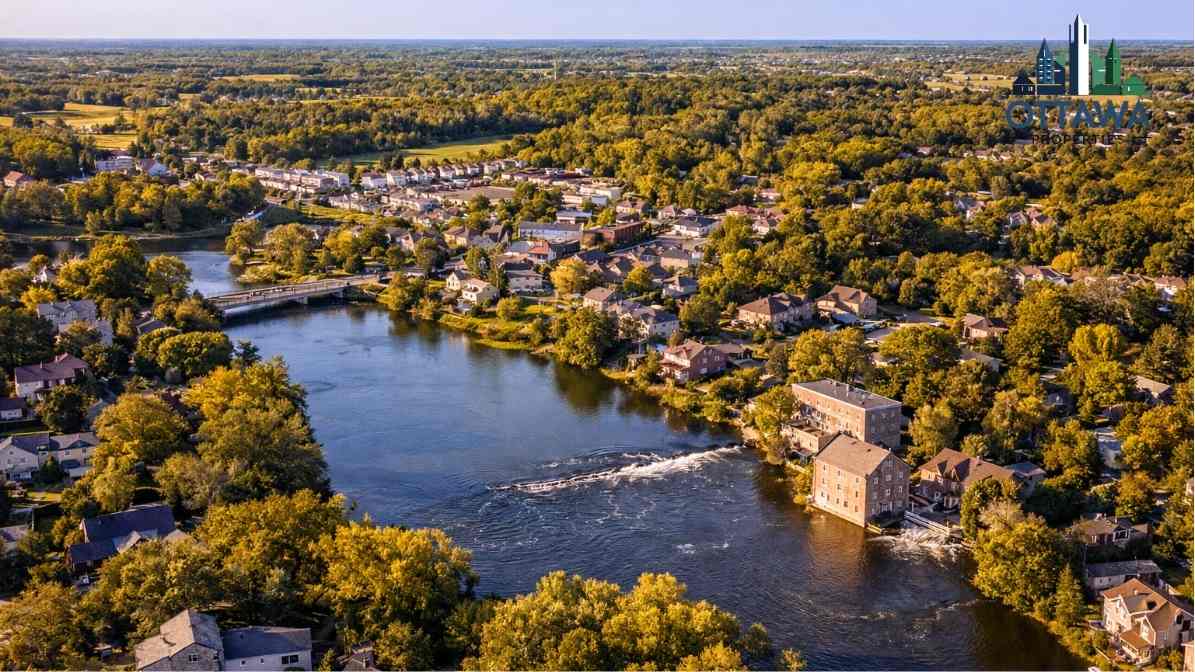Aerial view of a scenic Ottawa neighborhood featuring residential homes, a river, and lush greenery, highlighting the community's charm and outdoor appeal.