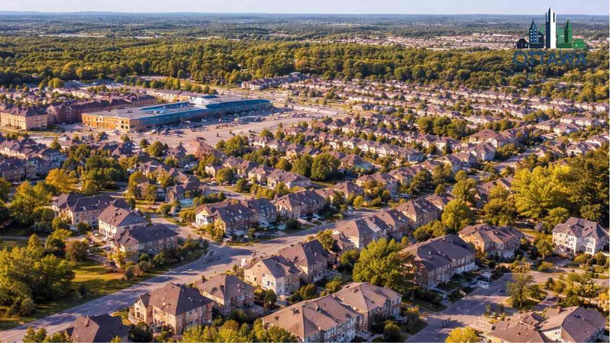 Aerial view of suburban Ottawa neighborhood featuring residential homes, green trees, and a shopping area, illustrating family-friendly living options in communities like Kanata and Barrhaven.