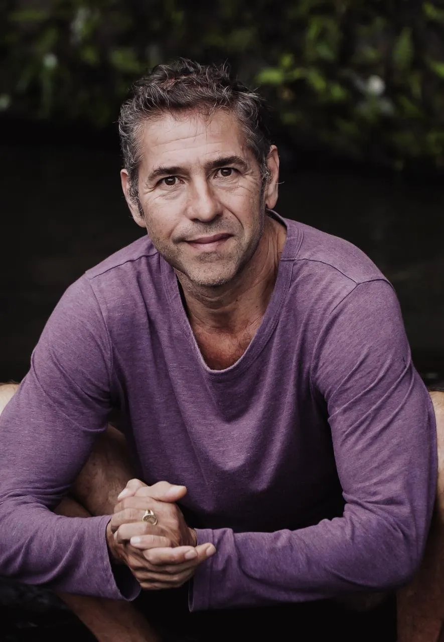 Matteo Morozzo, Somatic Experiencing Practitioner, sitting with his hands clasped