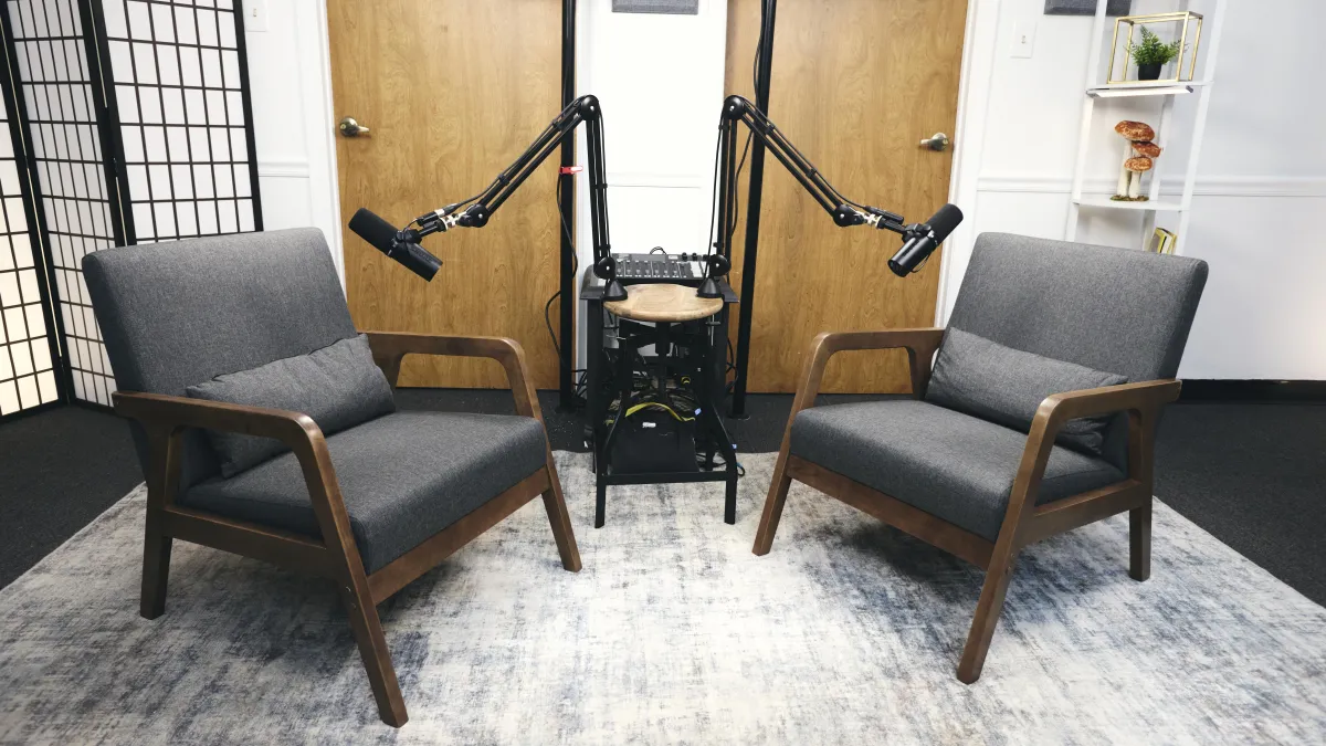 three person standing near wall inside building