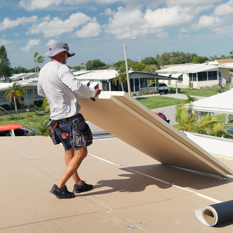 Mobile home roofing crew installing modern membrane roof system on low-slope roof