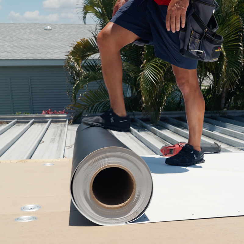 Palm Harbor Mobile Home Roofing contractor inspecting a low-slope manufactured home roof.
