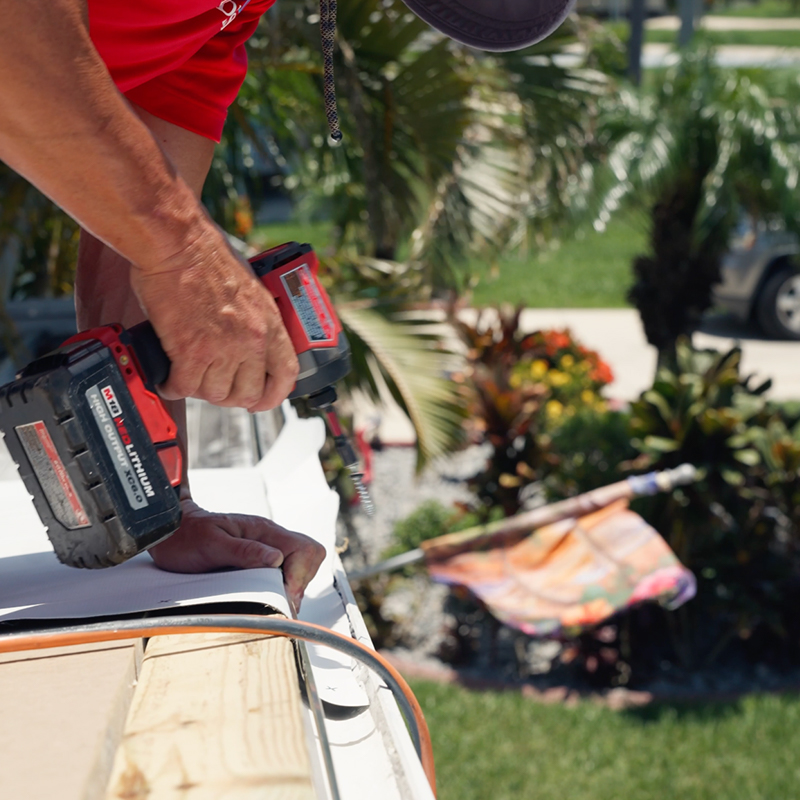 Sanibel crew repairing seams and flashing on an aging mobile home roof