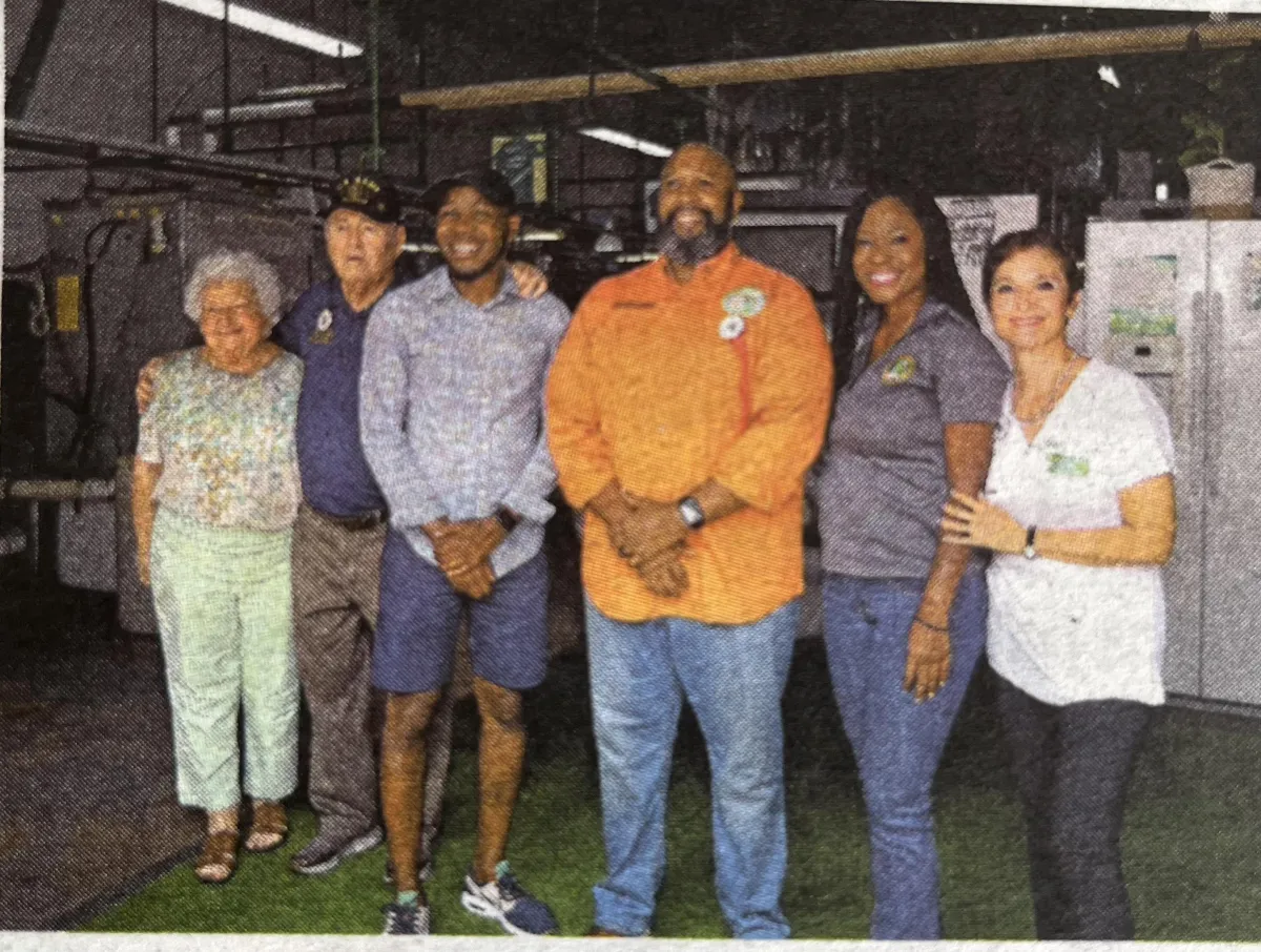 grand reopening picture of owner and councilman