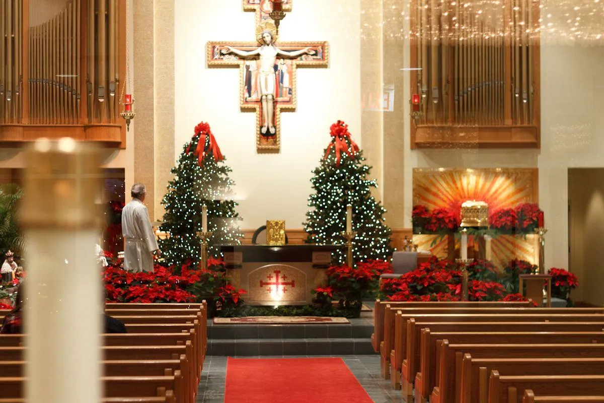 Elegant altar wreath centerpiece featuring glowing candles, pinecones, and holiday blooms, enhancing the Christmas spirit today.