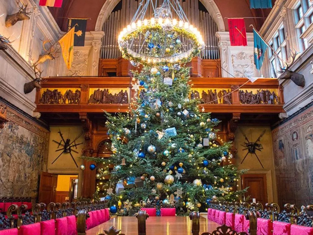 Hotel room adorned with sparkling lights, festive garlands, and cozy Christmas decor, creating magical holiday warmth.