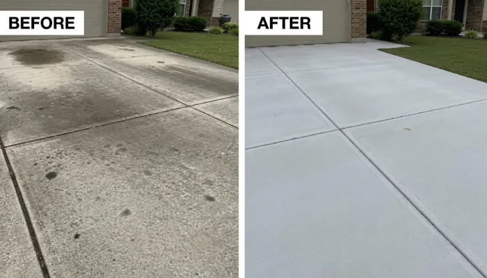 Salt stains and white haze on a concrete driveway after winter