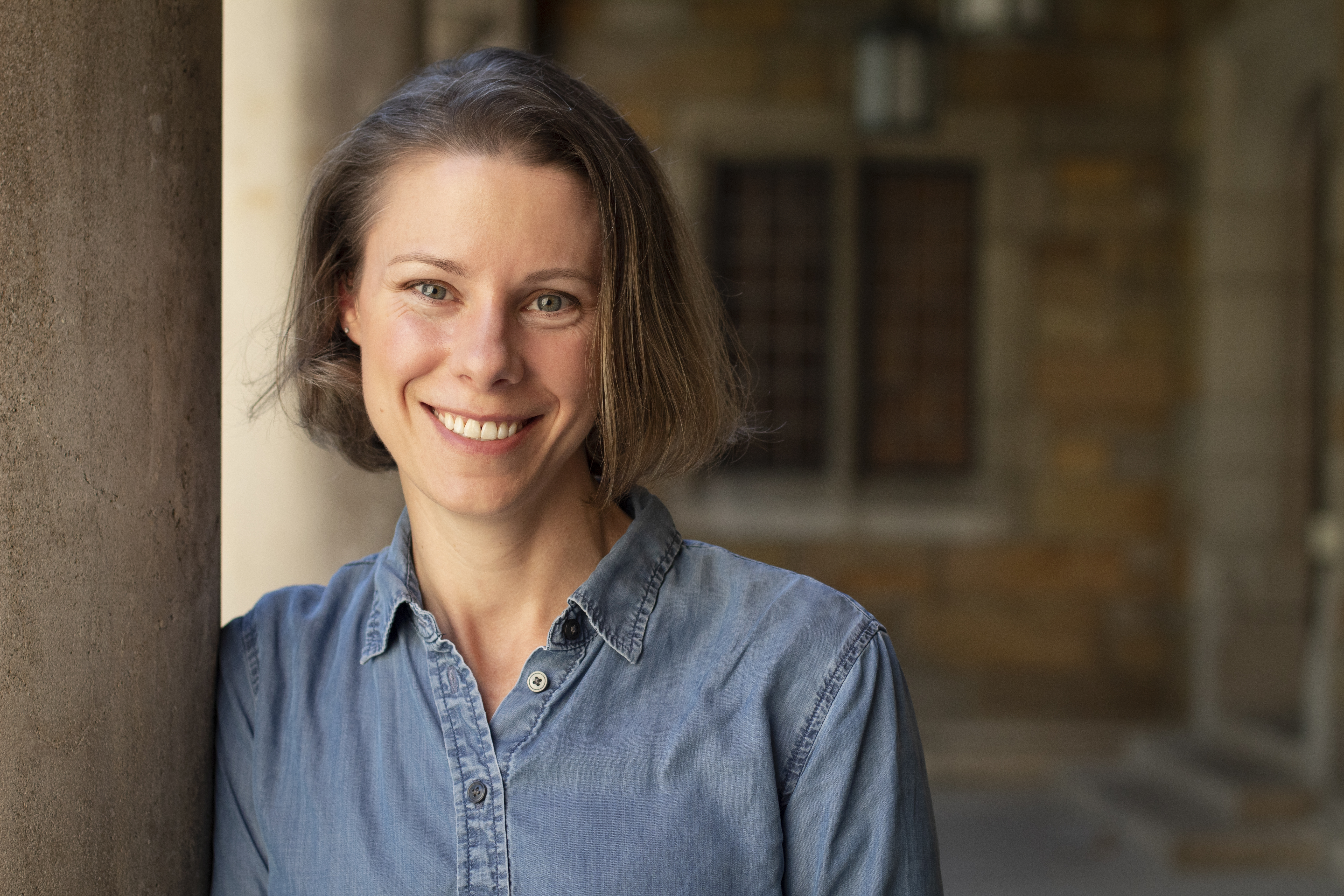 Tori Throckmorton leaning against a pillar and smiling