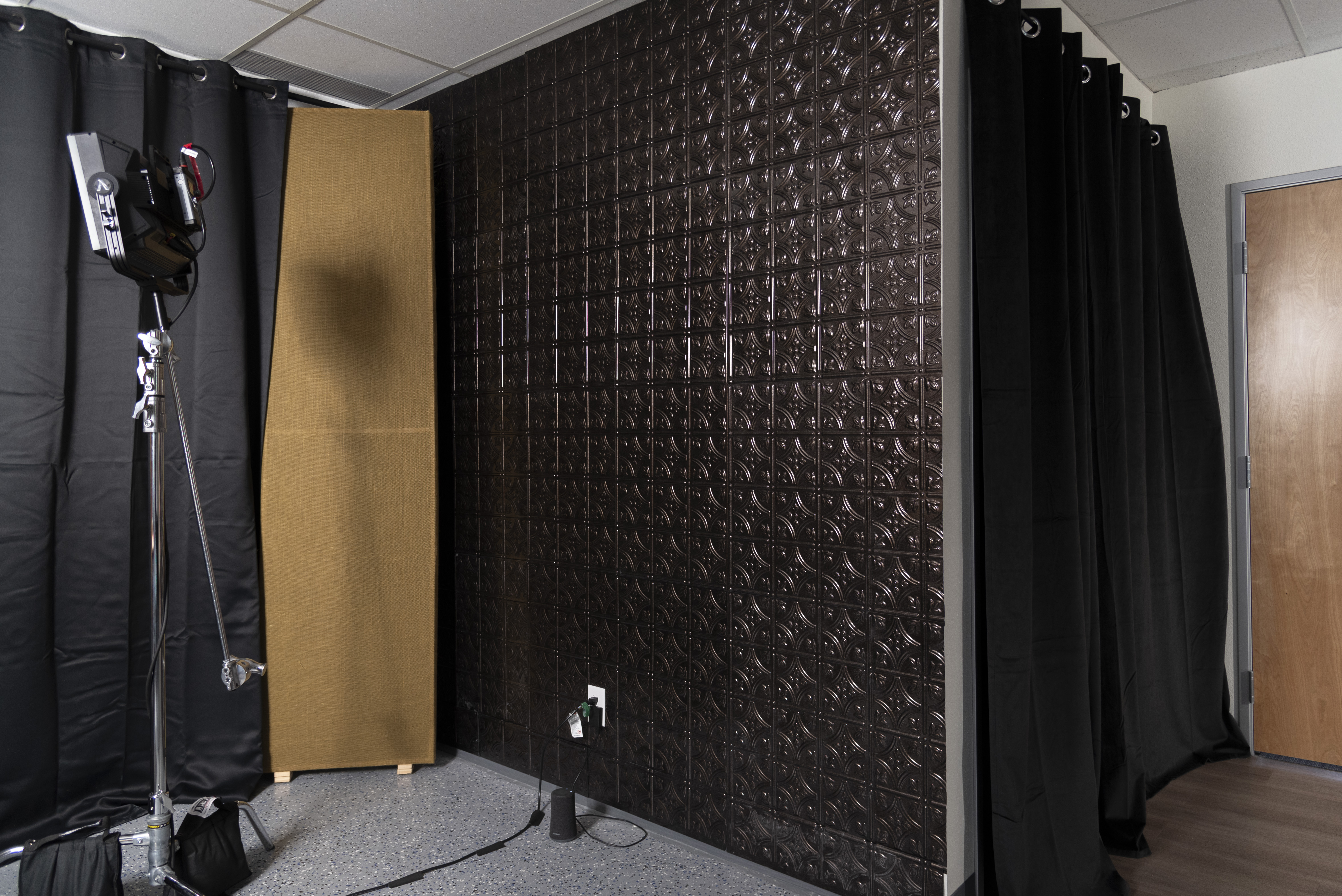 Black curtain and a decorative wall at In Real Life Studios