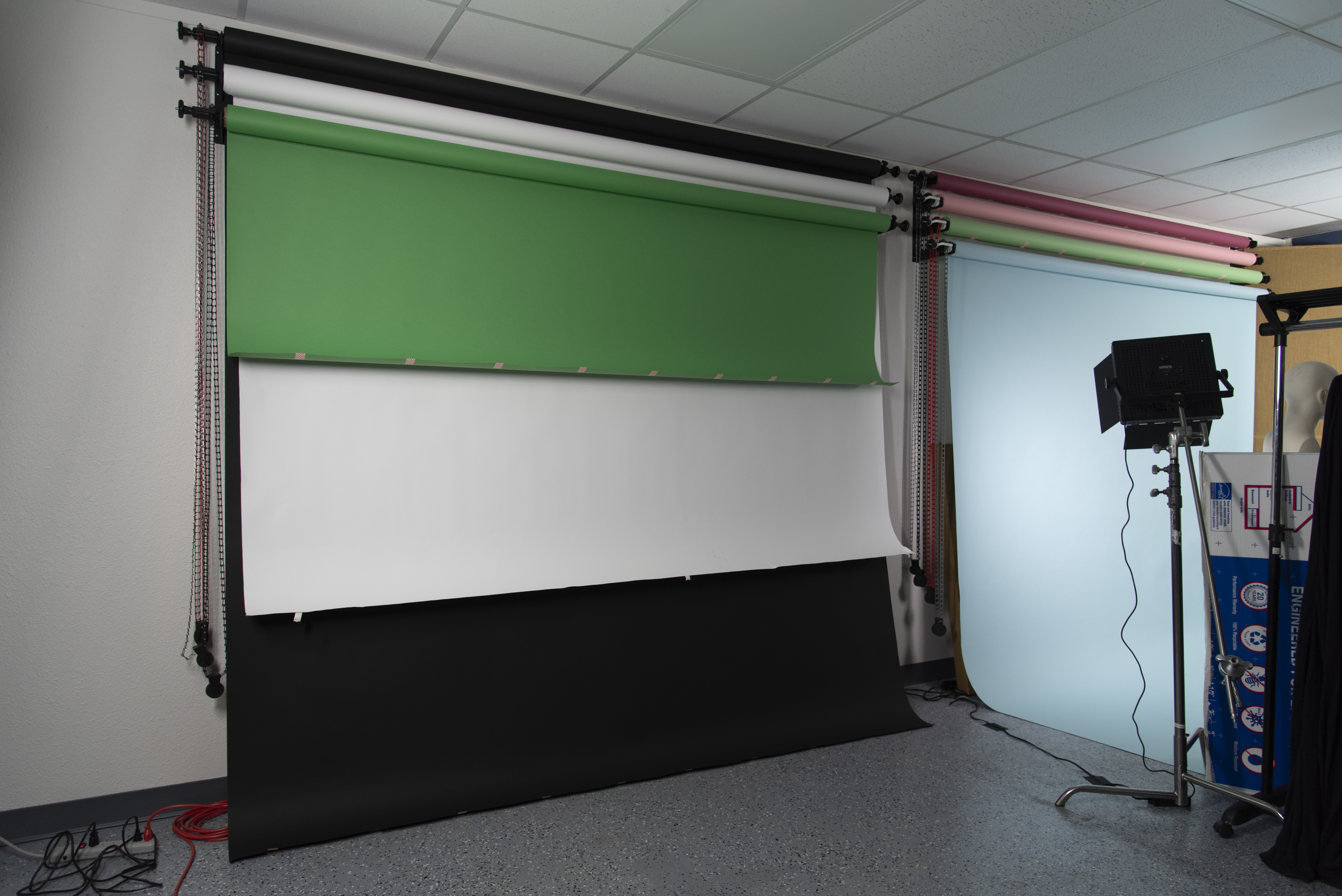Chroma key green, white, and back paper backdrops for use at In Real Life Studios