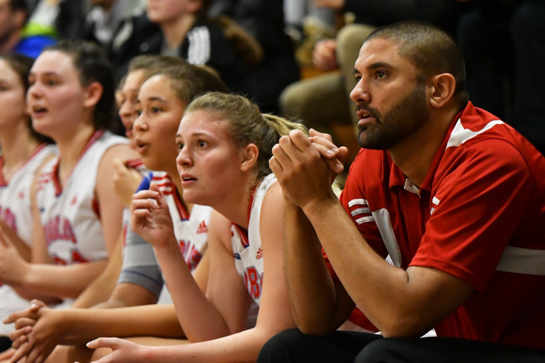 Coach Docter and players reacting courtside during a game