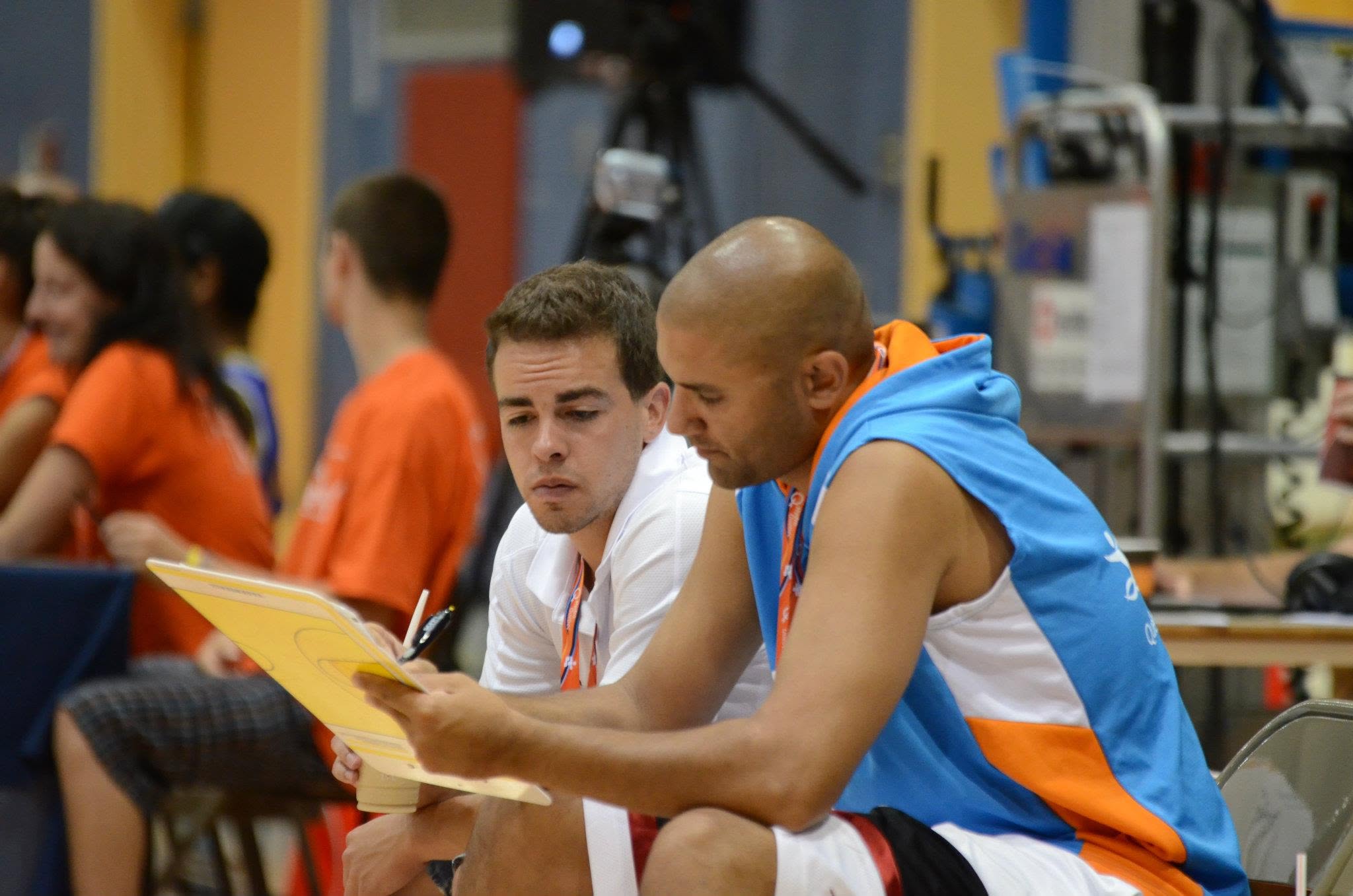 Coach Docter reviewing game notes with a player