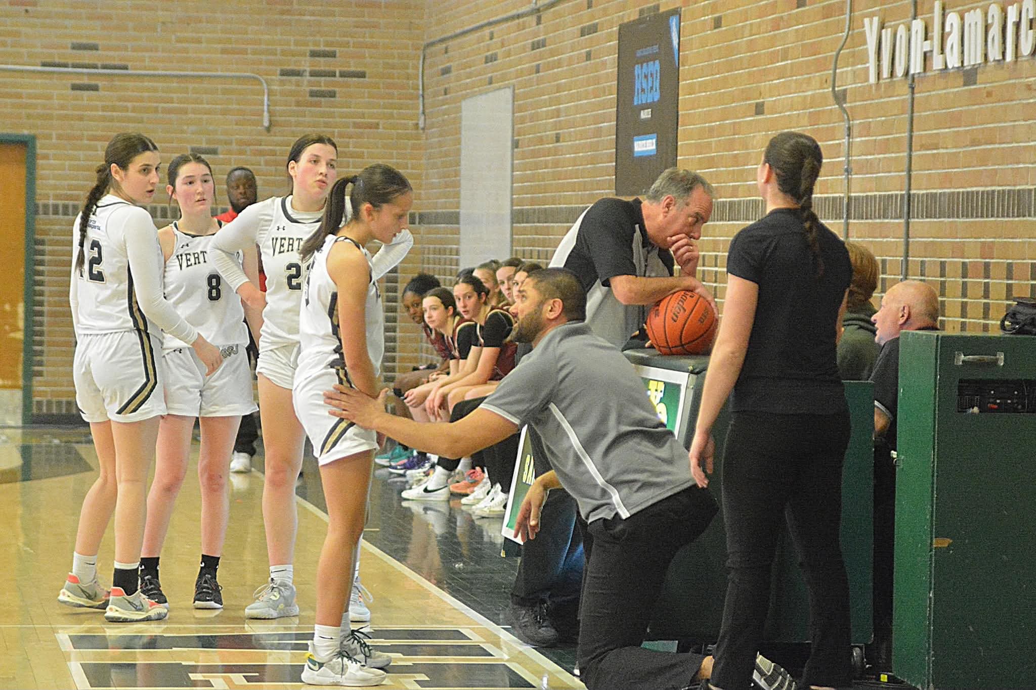 Coach Docter coaching a player courtside