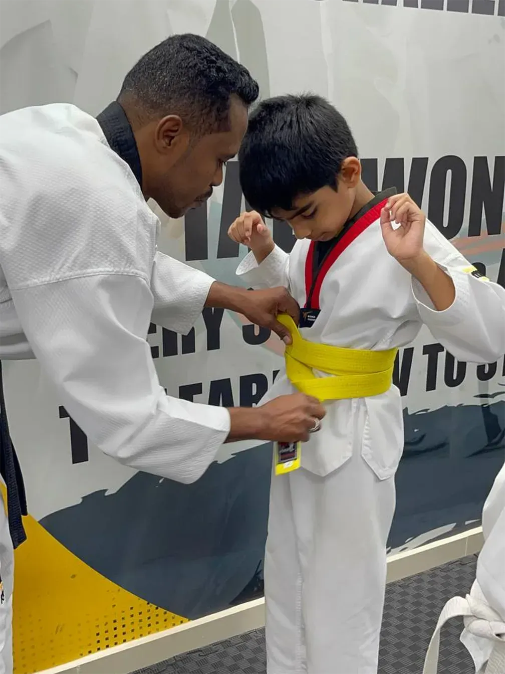 image - happy boy with instructor after taekwondo training