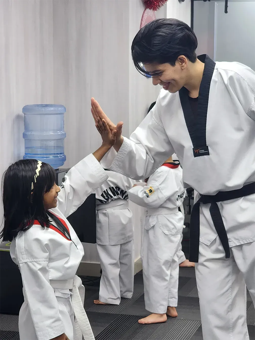 image - happy girl with instructor after taekwondo training