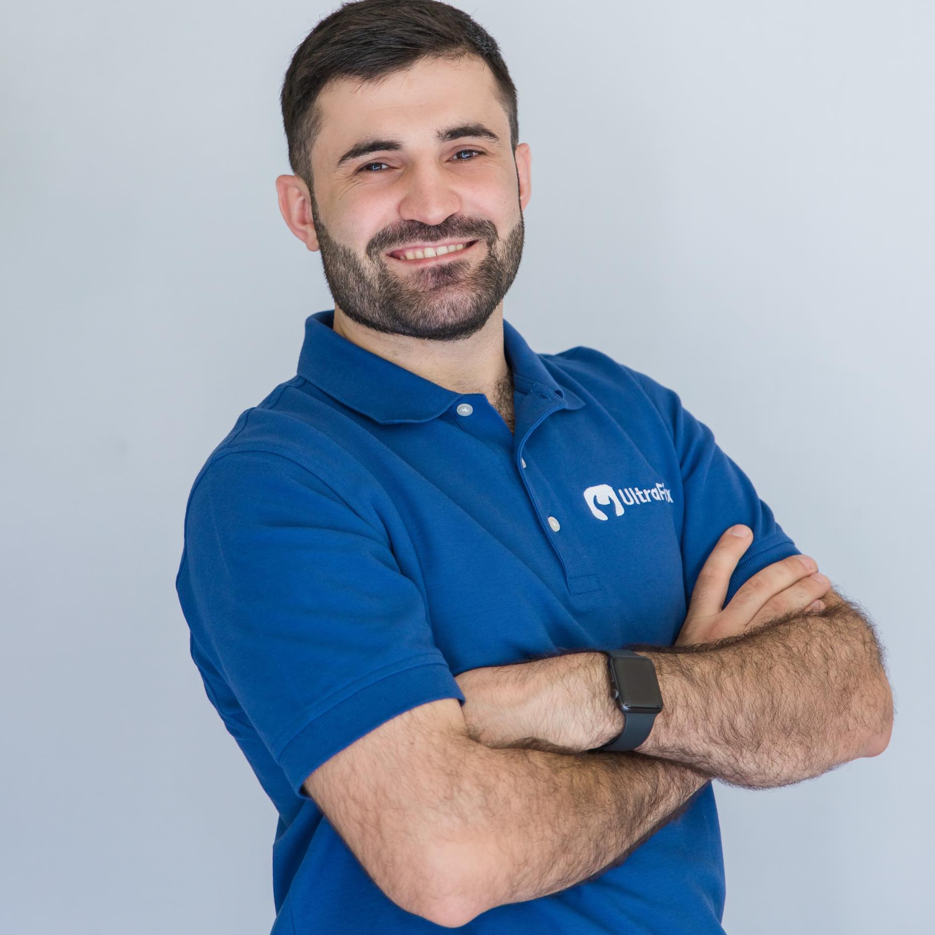 Mechanic using screwdriver on car engine