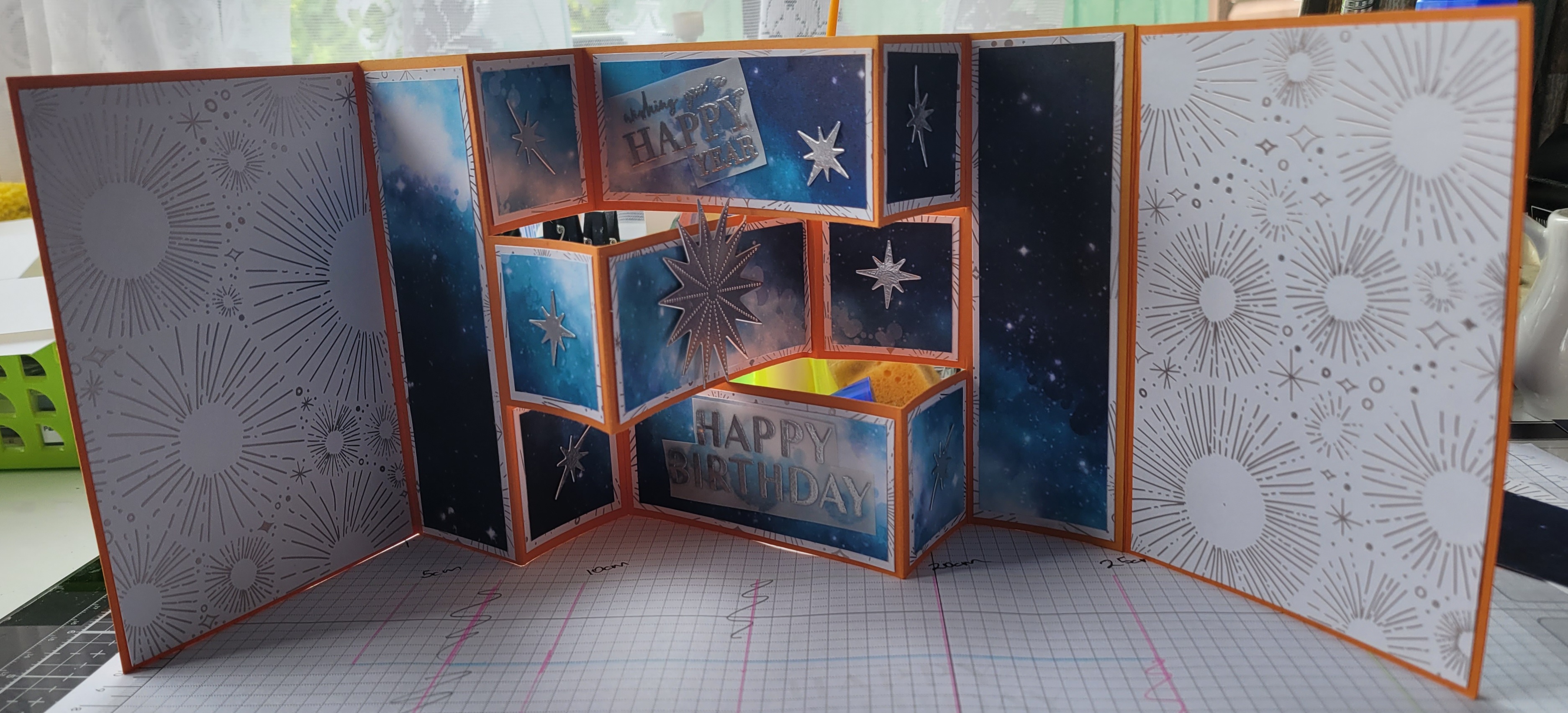 Birthday card with 4 panels; theme is whie and silver with star bursts