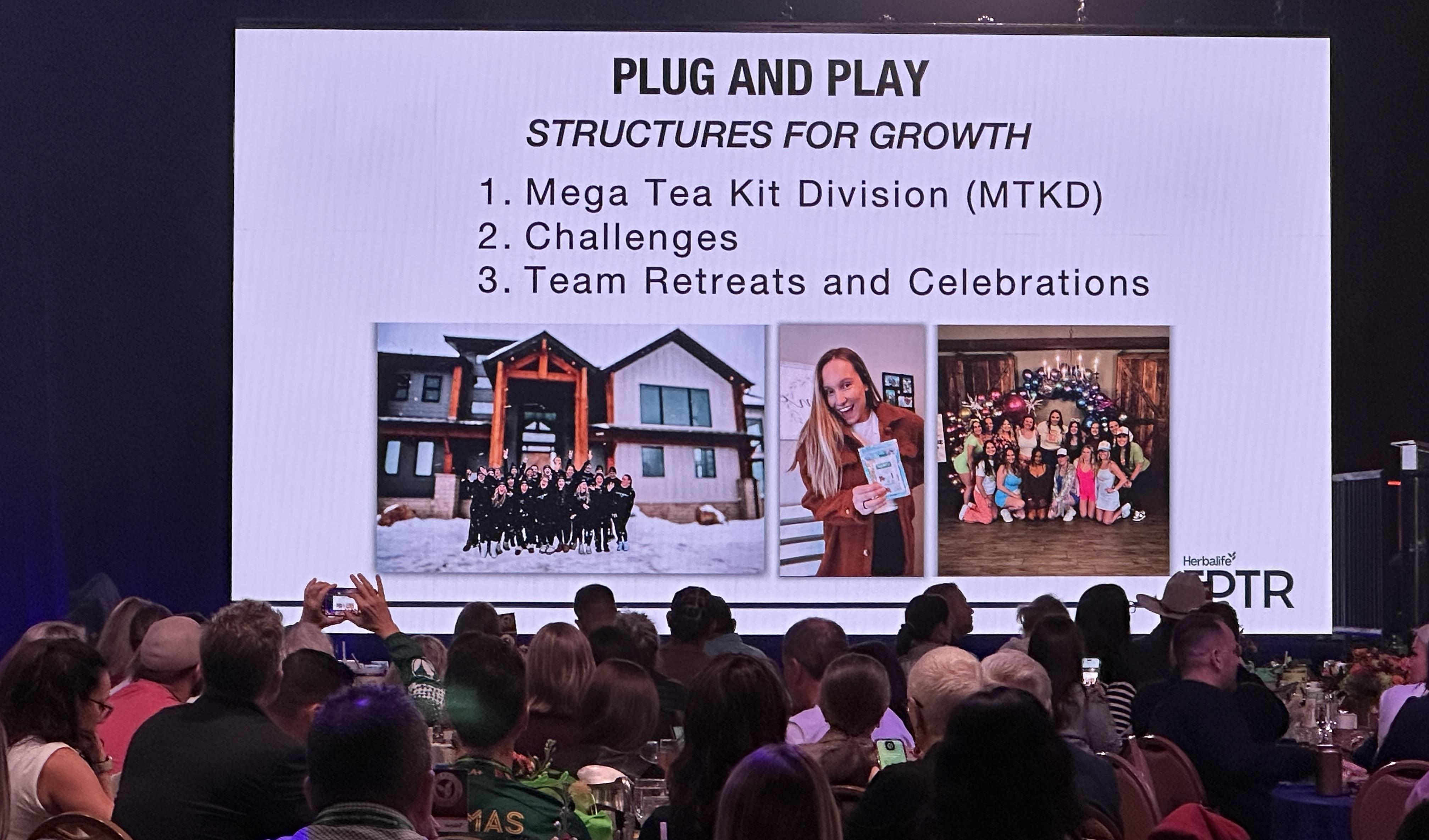 Young parent working on a laptop at a kitchen table while a child draws nearby, showing work-life balance