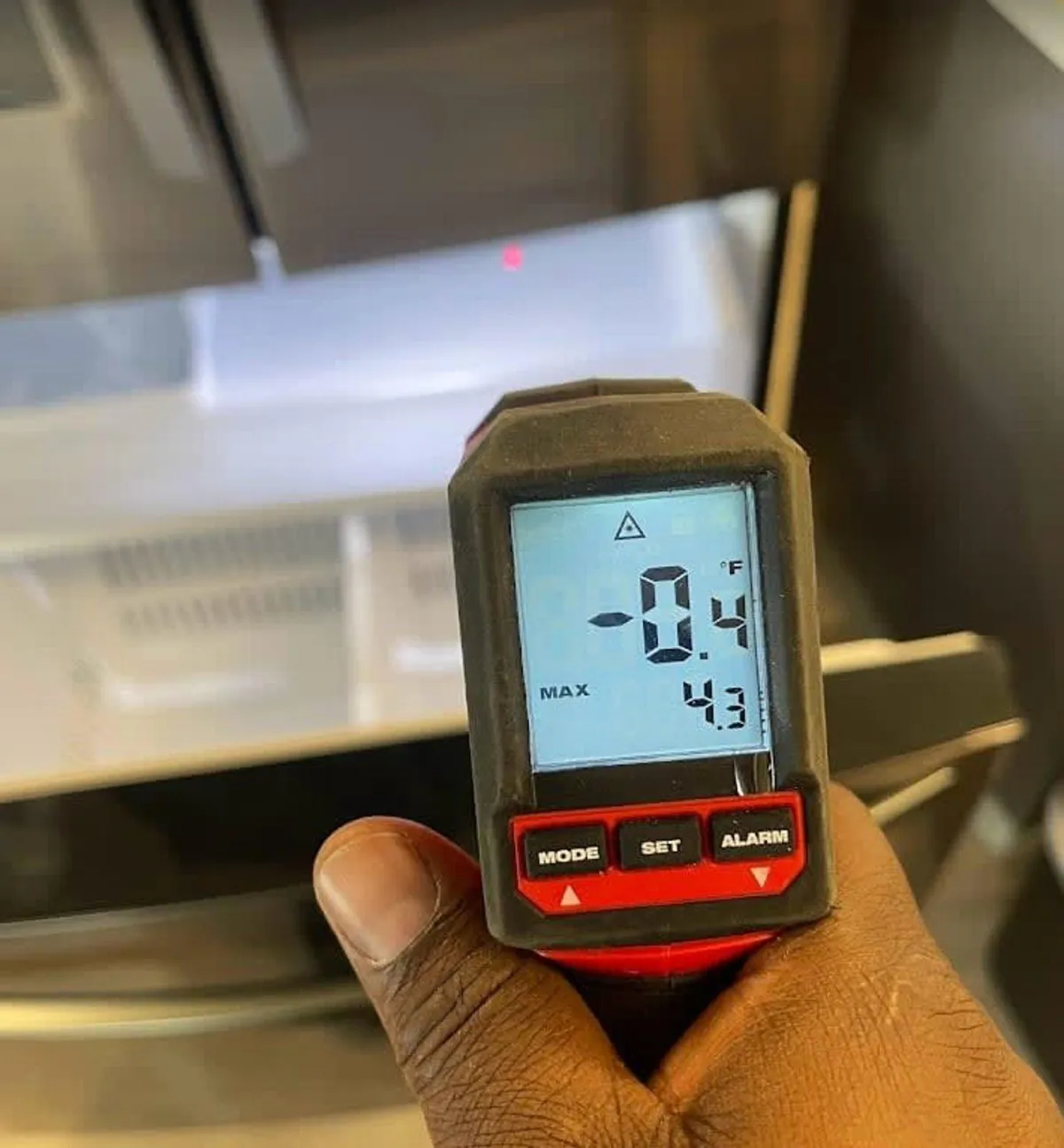 Certified HVAC technician using a diagnostic tool to assess an air conditioning system in Maryland.