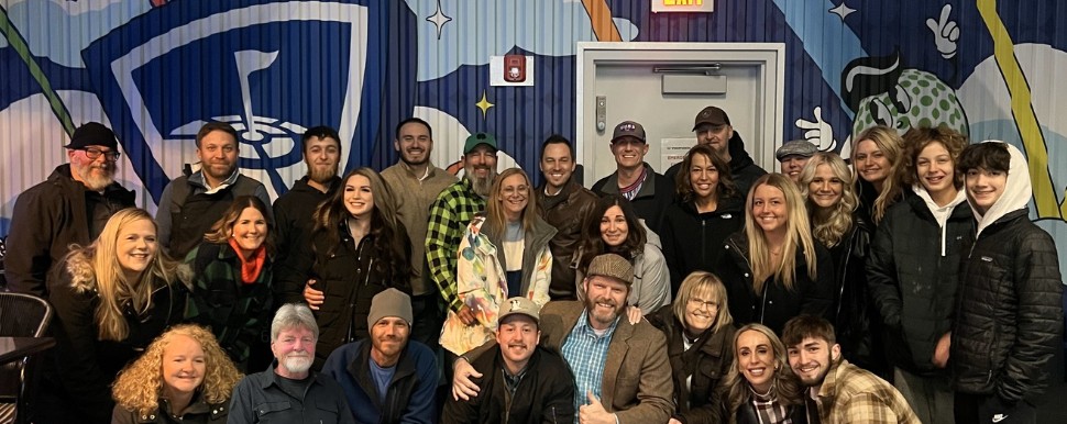 Group photo of Right Roofing & Siding employees celebrating teamwork and company culture, showcasing diverse individuals in a casual setting.