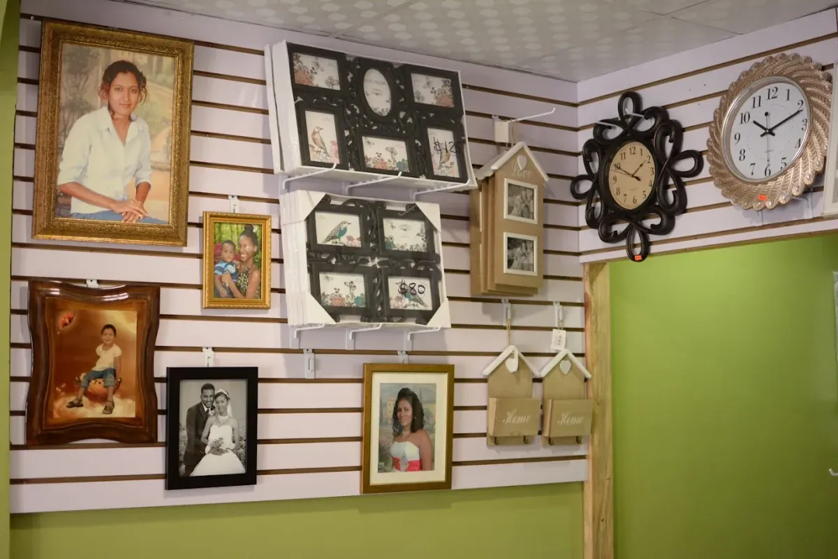 A joyful family of four, diverse in age and ethnicity, laughing together during a professional indoor photo shoot. The background is softly blurred, with studio lighting highlighting their expressions. The composition captures genuine connection and happiness, emphasizing the warmth and expertise of Ghatie's Photo Studio.