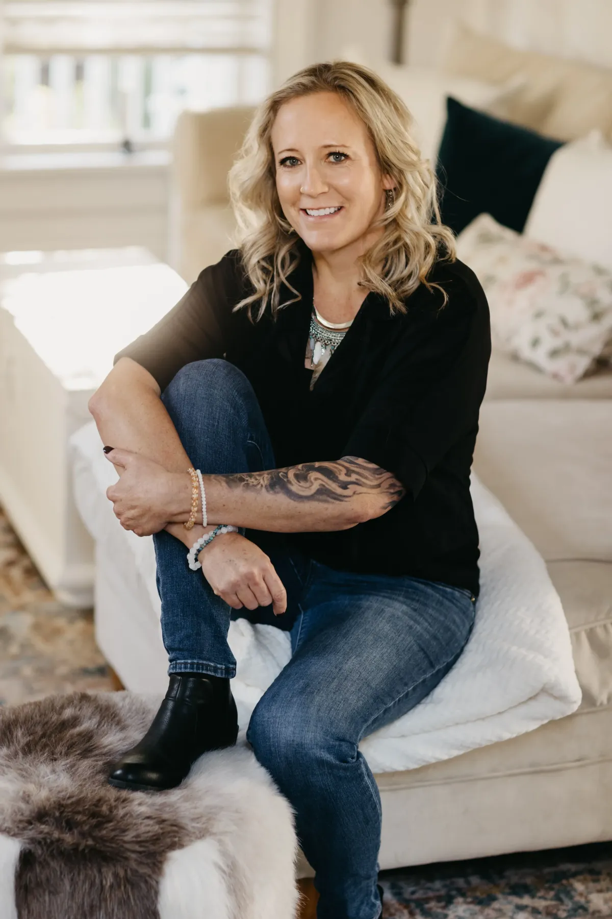 Jessica Alexus seated indoors, embodying calm and grounded energy