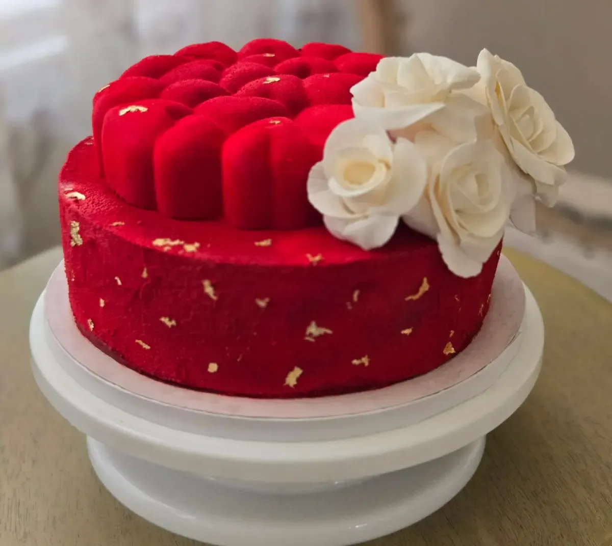 Custom birthday cake with red velvet design and white floral decoration