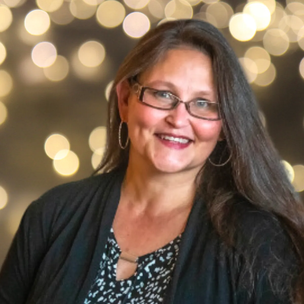 Carrie Hurley n front of a blurred background of lights