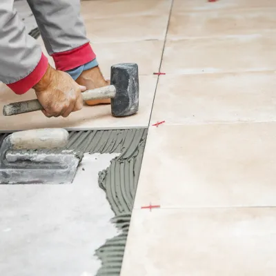 Worker installing ceramic flooring