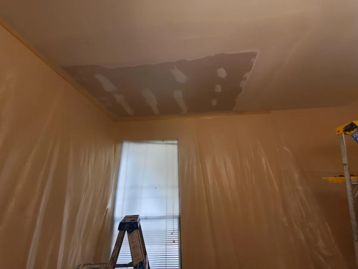 Skyscrapers under construction with cranes against sky.