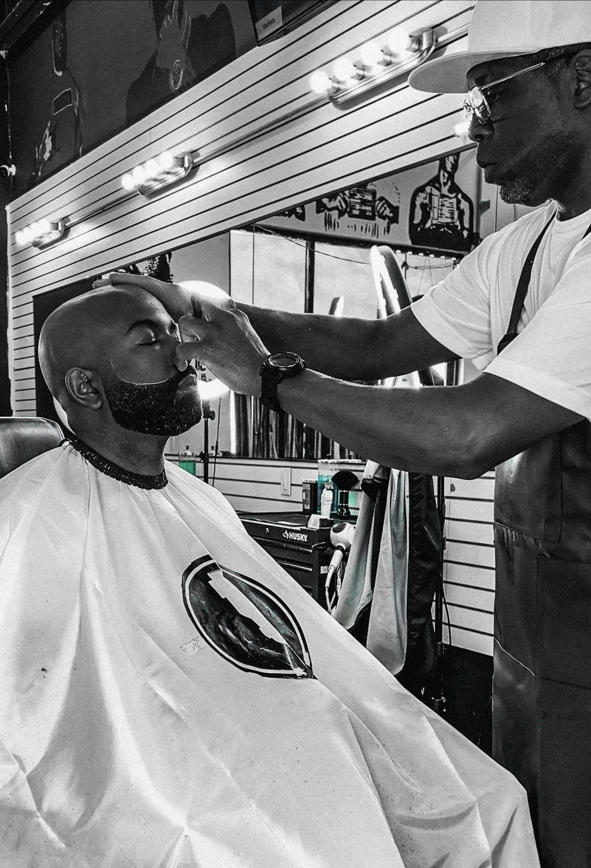 man in white dress shirt cutting hair of man in white dress shirt