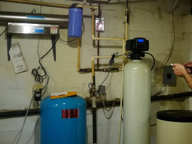 Eastside Repipe And Plumbing technician installing a whole-home water filtration system in Bellevue WA