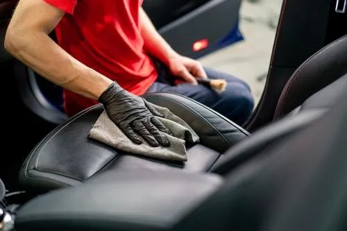 A man wiping a car seat representing our full interior detail