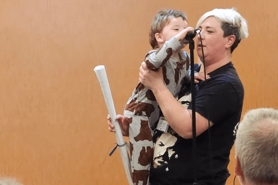 Several people gathered in a spacious room, sitting together while someone is delivering his speech during Insight II