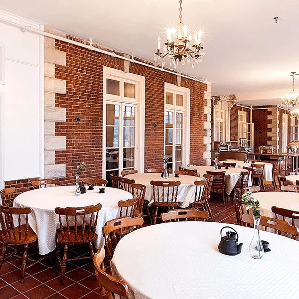 The dining room at The mansion at Eastover, showcasing contemporary furnishings and a vibrant atmosphere for dining.