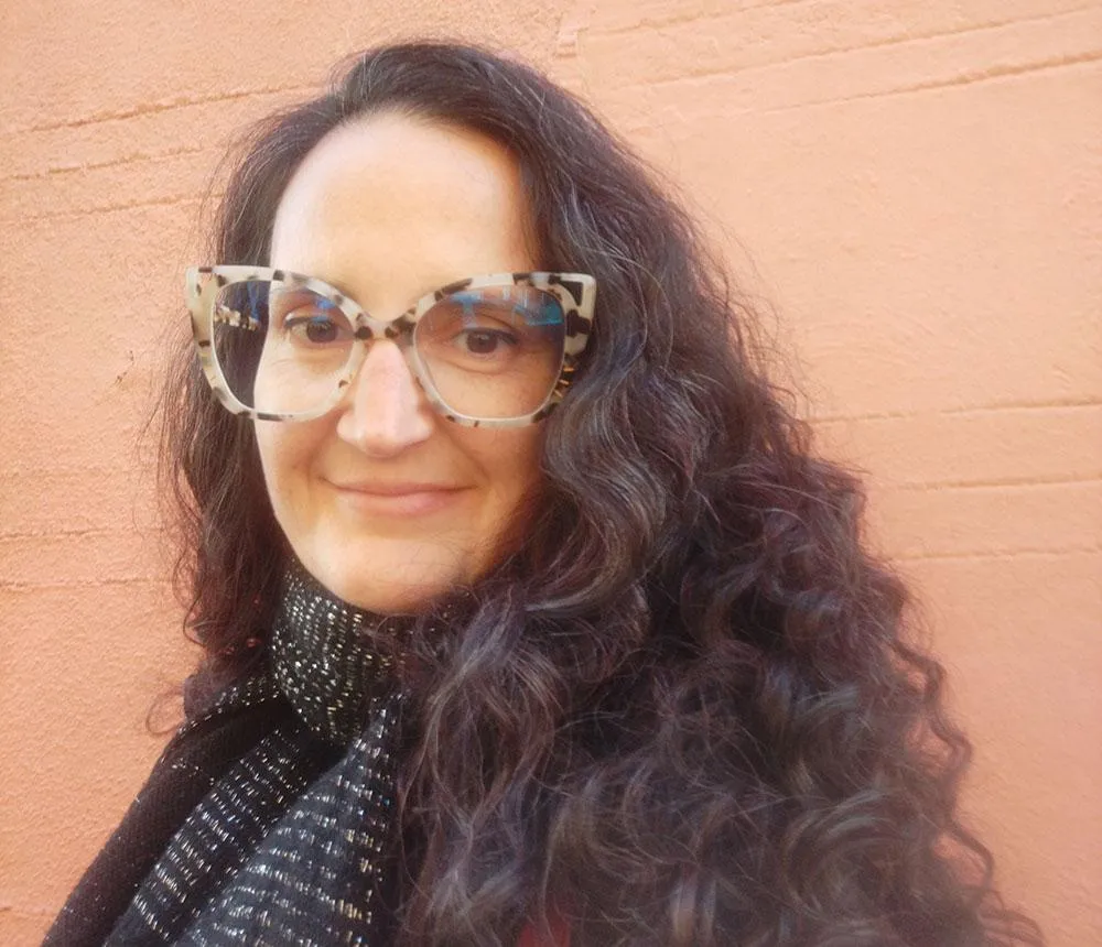 a woman is holding a cup of coffee