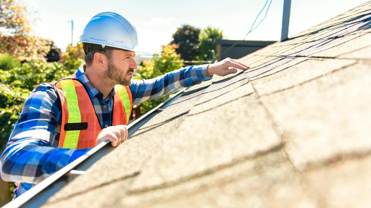 Roofing contractor inspecting Montgomery AL home for roof damage