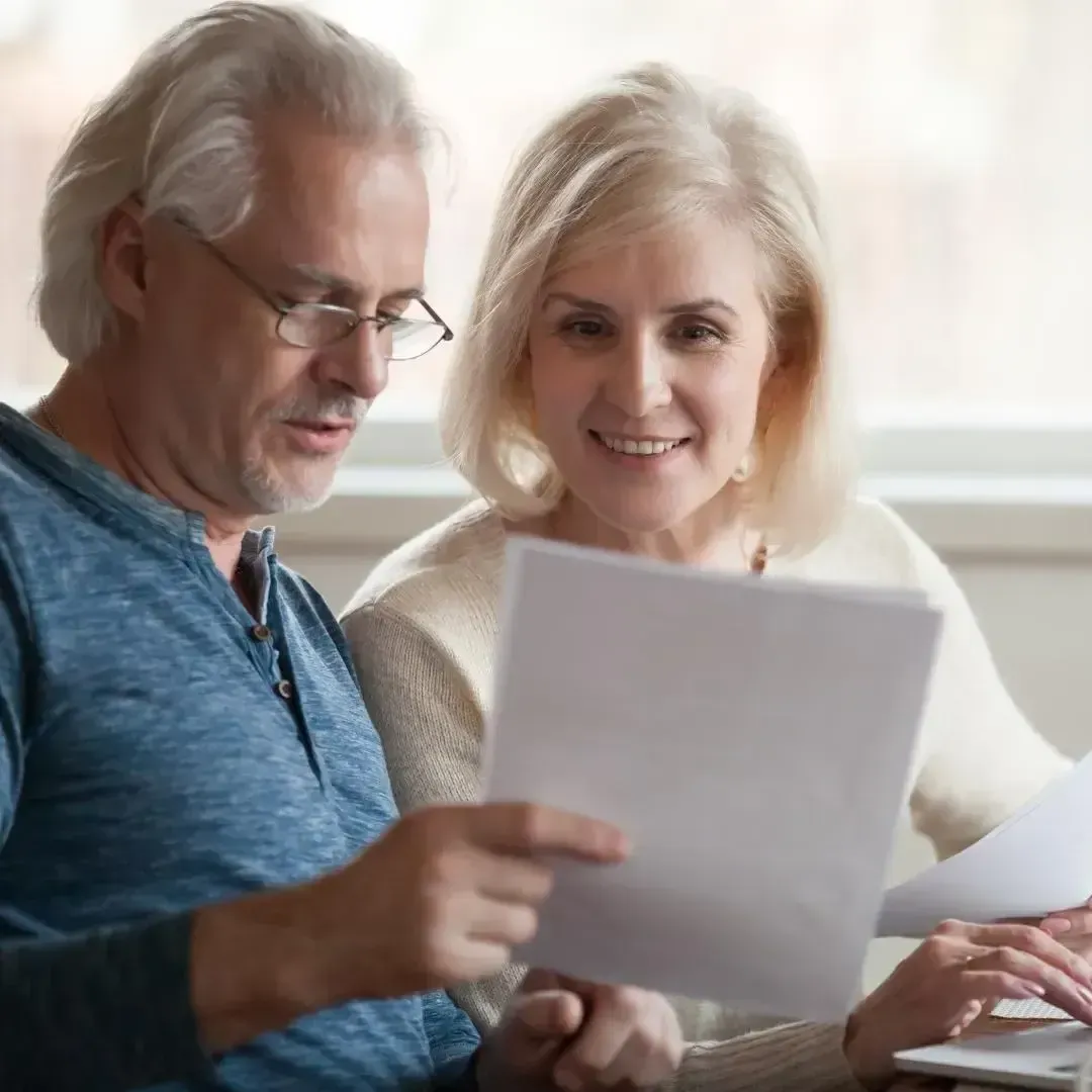 Homeowners reviewing a storm damage roofing insurance claim with help from Dunning Roofing