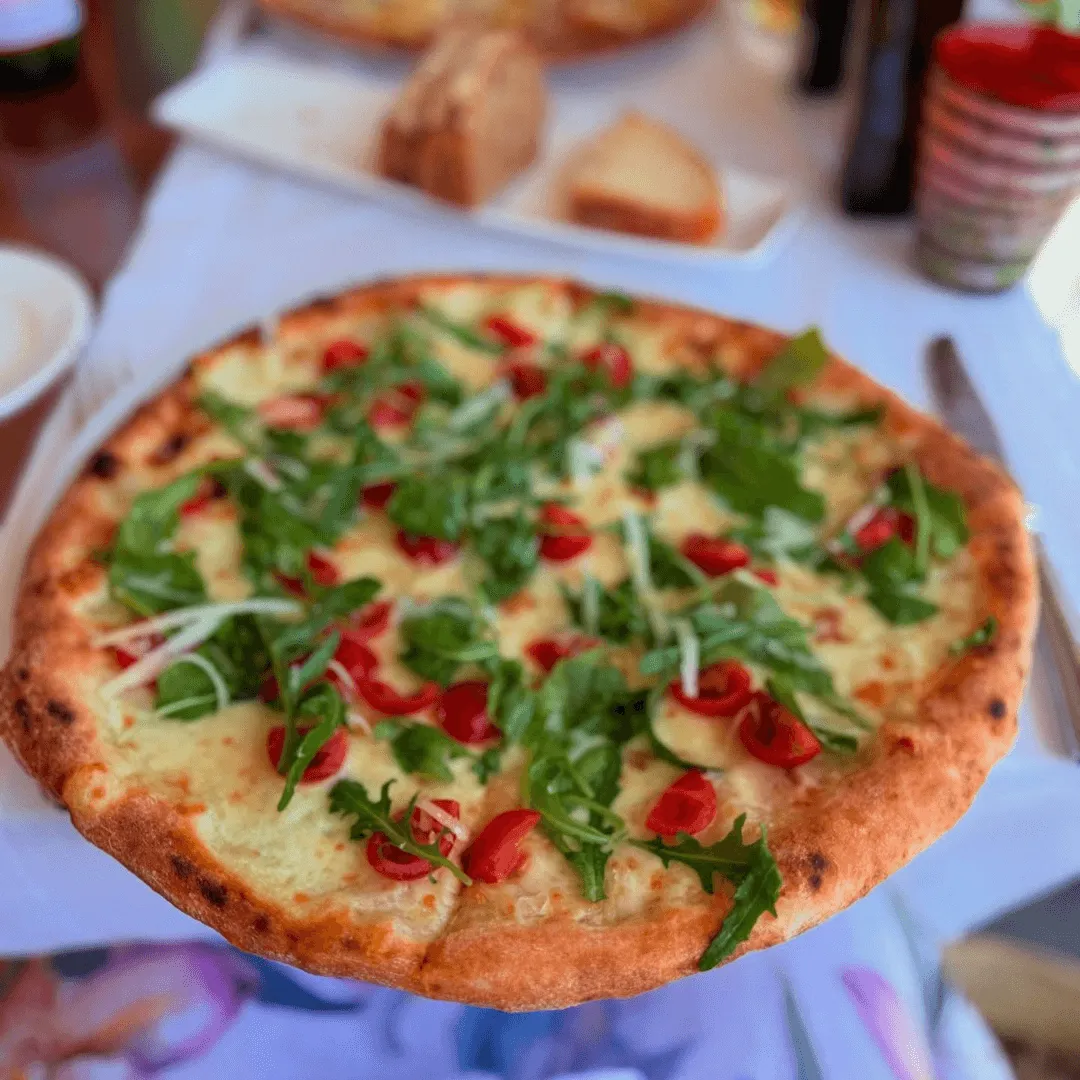 A pizza so fresh it should be arrested, booked by Mariola San Juan of Orlando, Florida at a hidden Italian trattoria