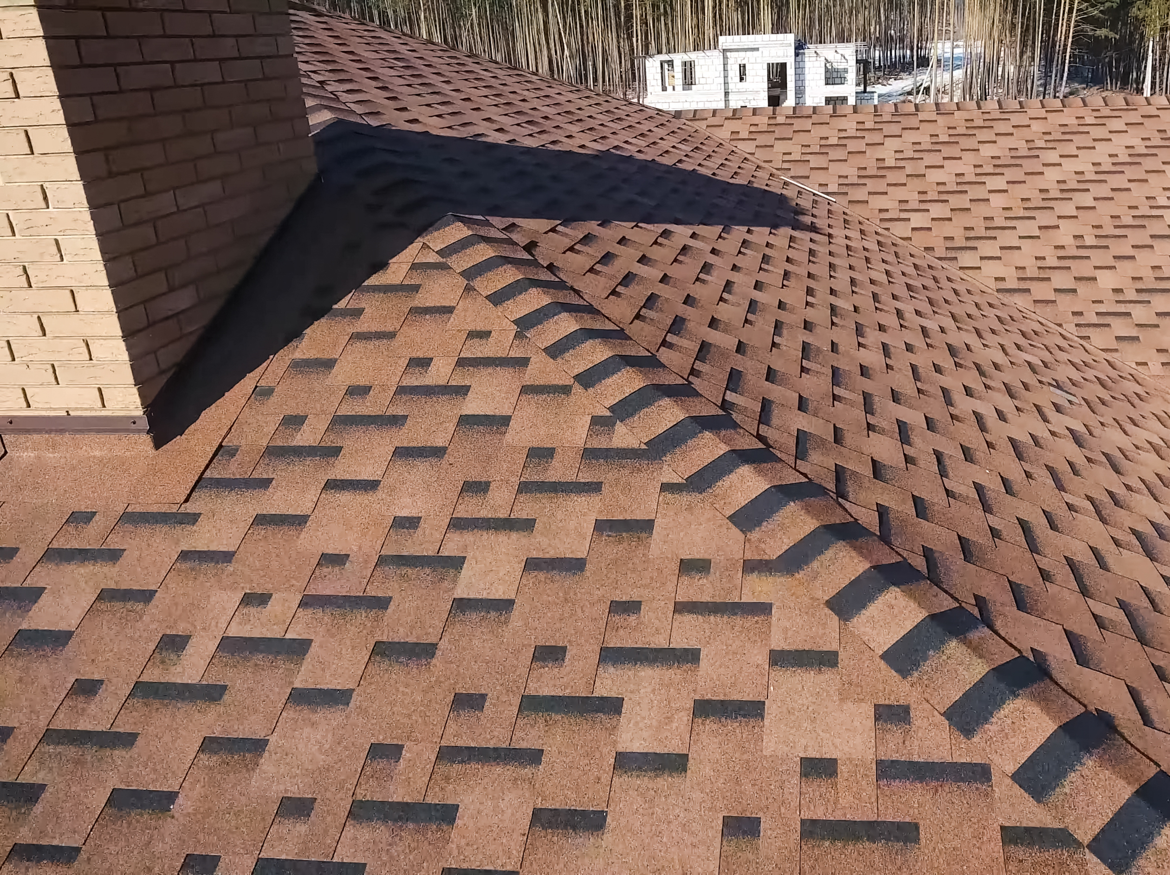 Roofing crew installing a strong new roof on a home in Babylon, NY