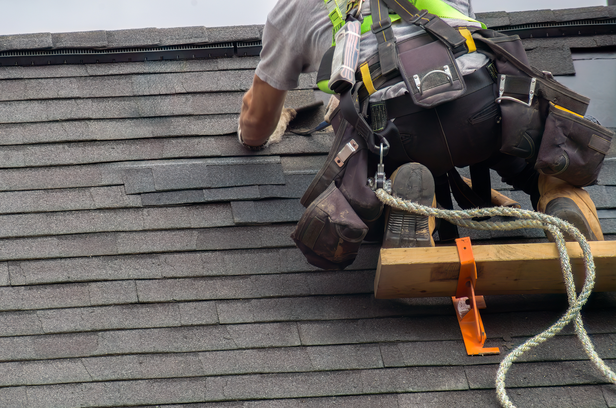 Roofing repair in Bay Shore, NY on a home with damaged shingles and active repair work