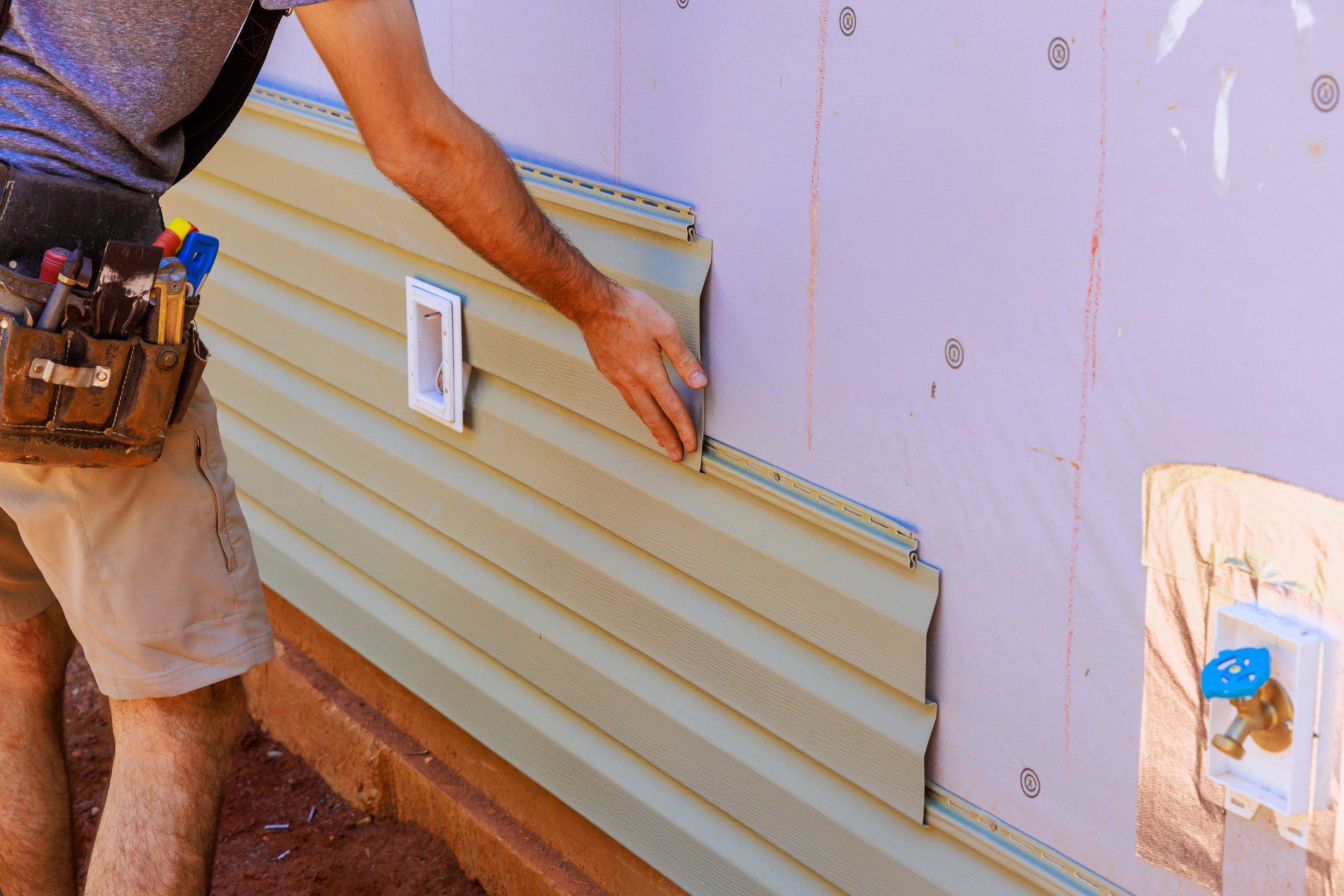Home exterior with siding repair in Babylon, NY and clean updated panels