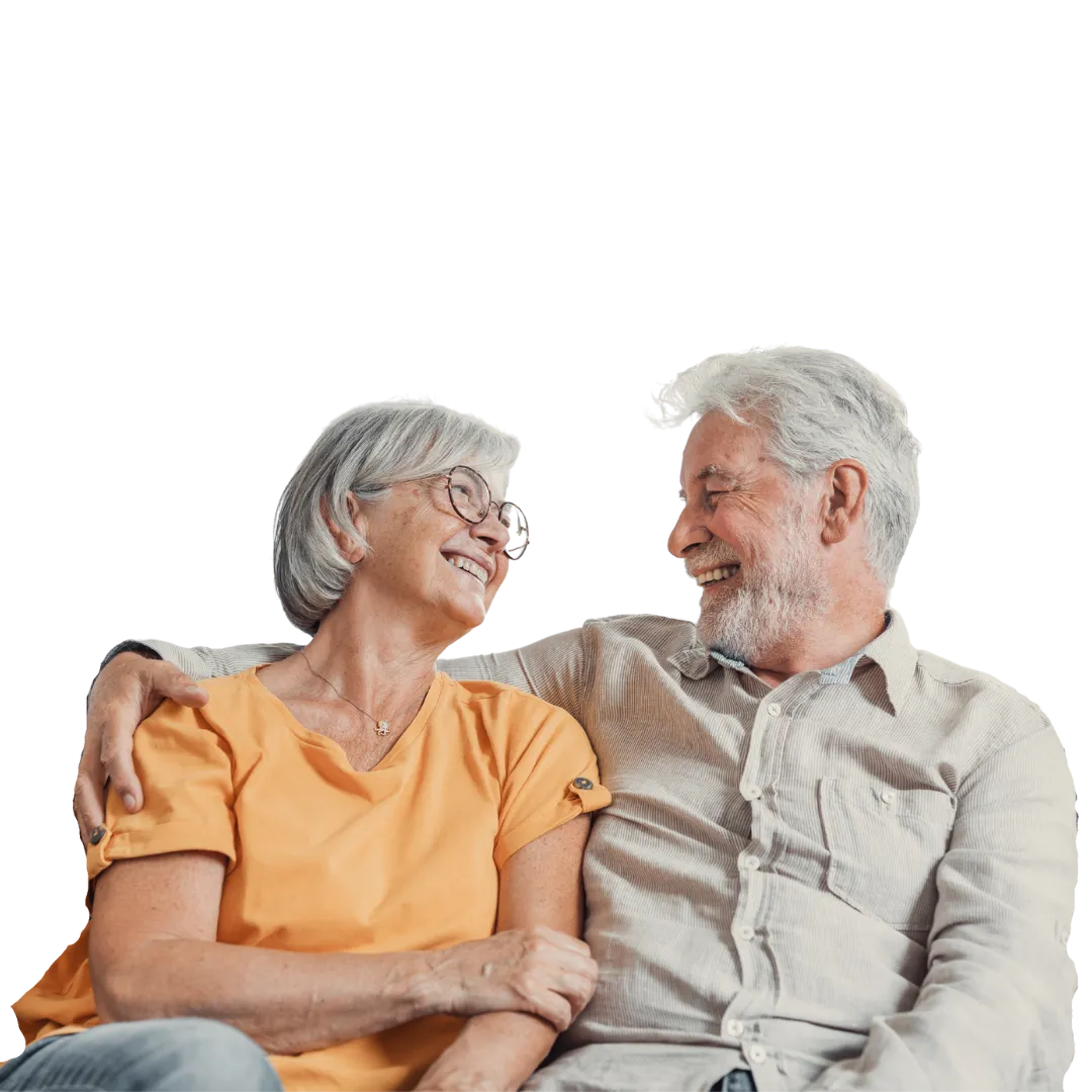 Elderly couple smiling after finding a Medicare and life insurance agency they trust for all their coverage needs.