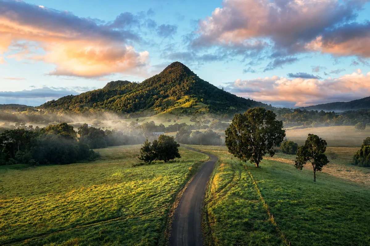 Misty mountain and country road at sunrise in the Maleny hinterland